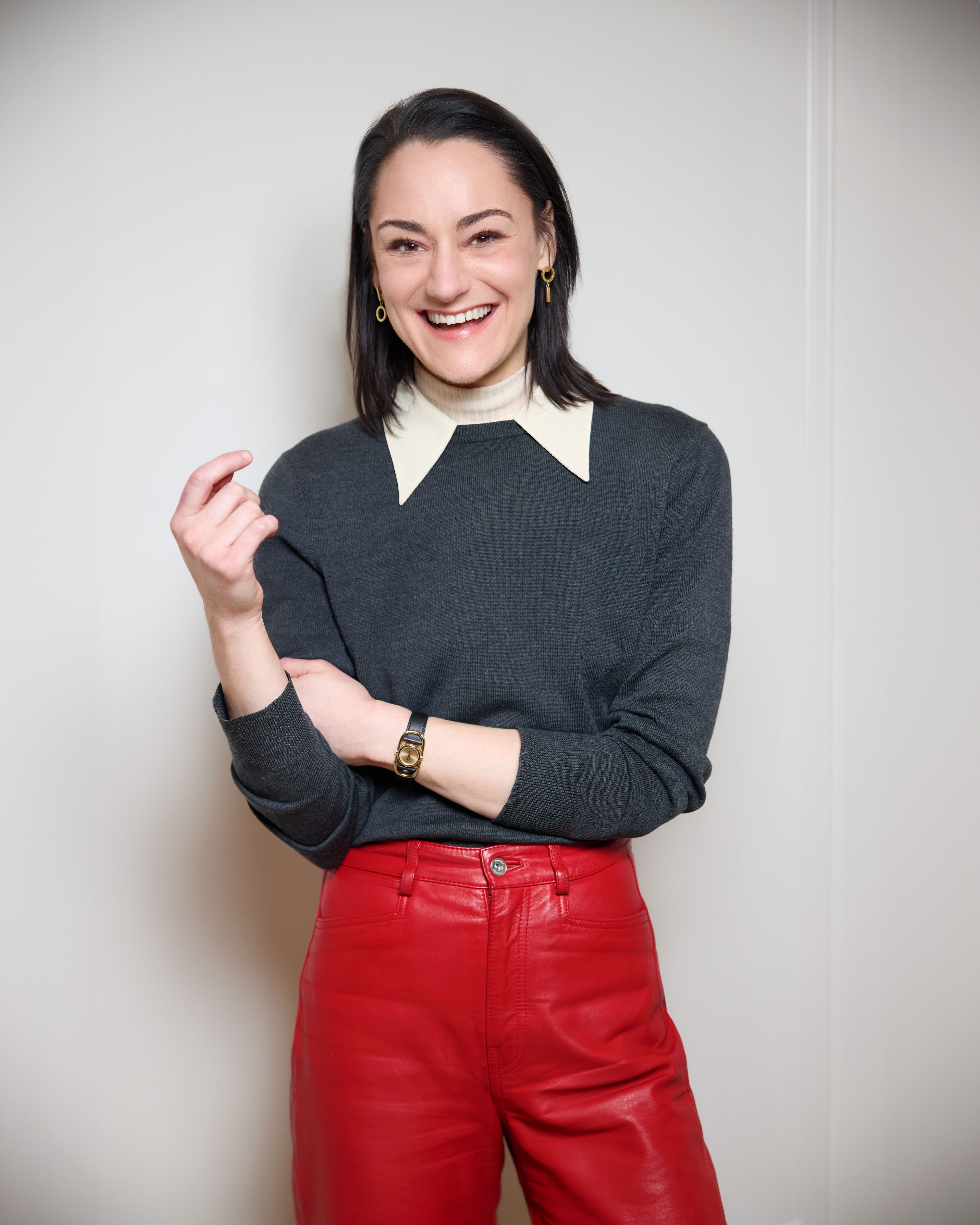 Kelsy Posthlethwait standing and smiling against a white backdrop.