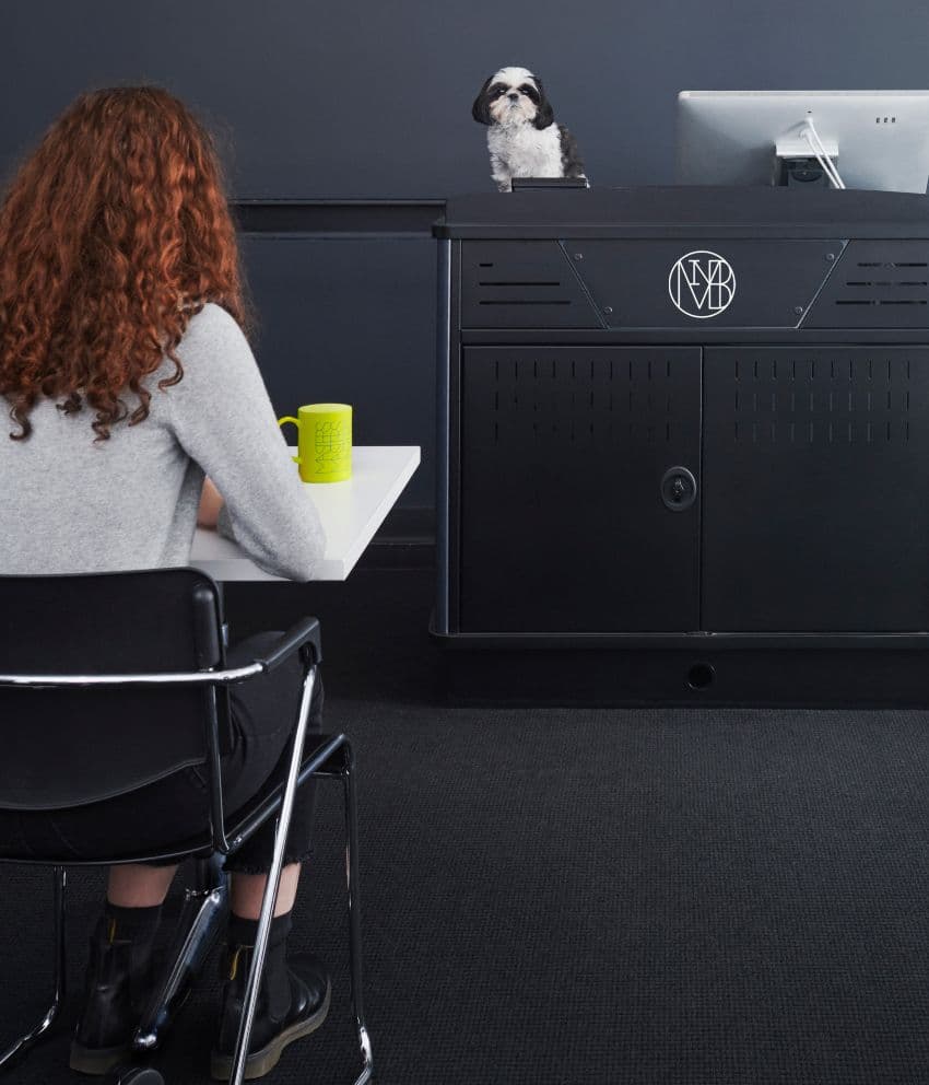 Student seated at desk facing an SVA-branded podium